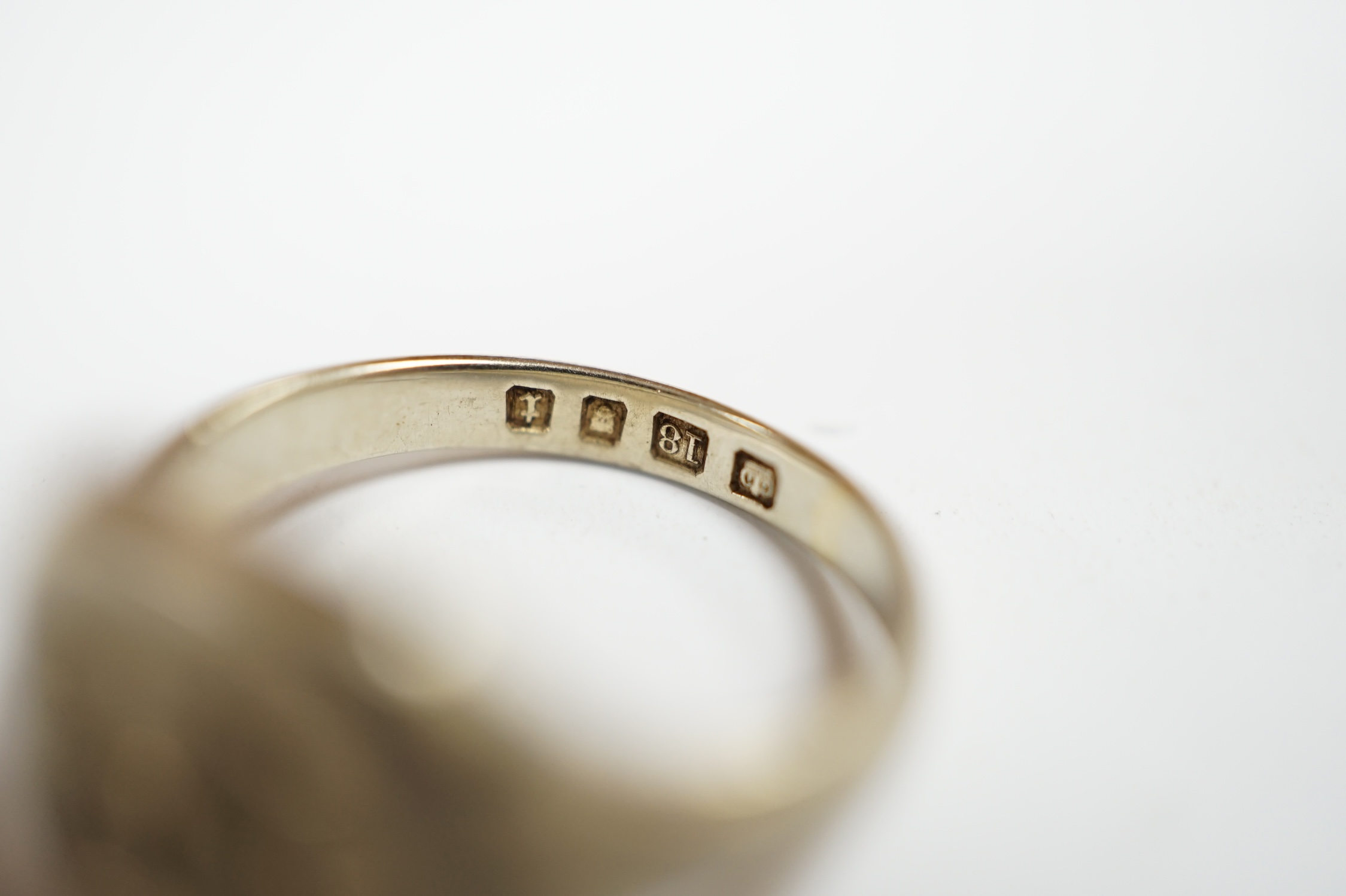A George V 18ct white gold signet ring, carved with a crest, London, 1934, size I, 5.7 grams. Condition - fair